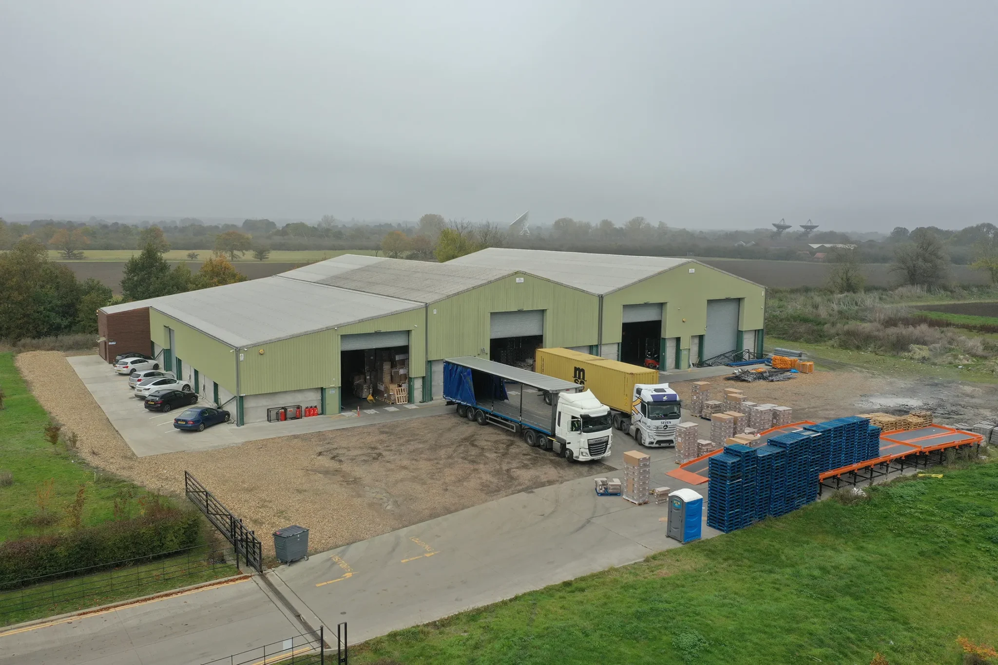 Aerial view of the warehouse, loading bays, trucks and storage yard